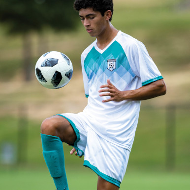 Soccer Player bouncing a ball on his knee
